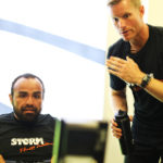 Standard pathway - man rowing and being encouraged by trainer